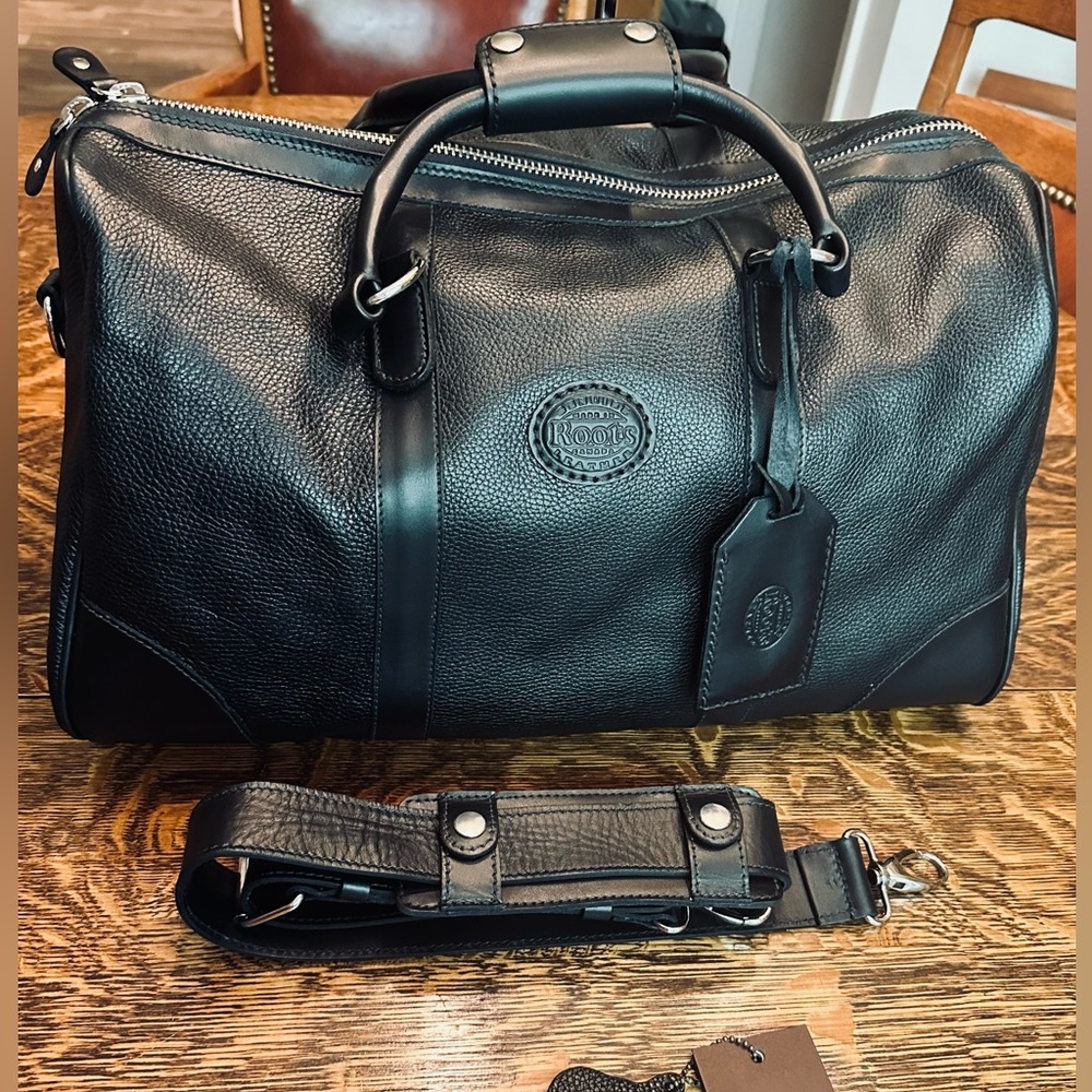 Roots Canada small Black leather Banff Travel bag. Brand new with tags